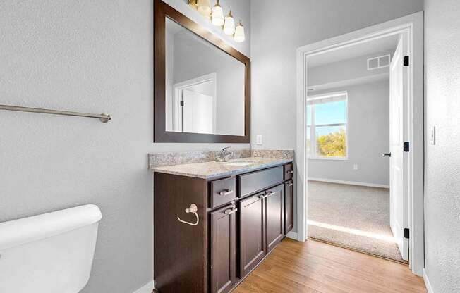 A bathroom with a white tub and a brown vanity.