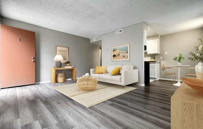 A living room with a white couch and a wooden coffee table.