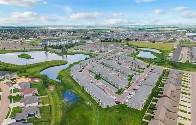 A bird's eye view of a residential area with houses and a river.