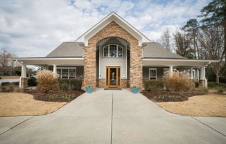 the front of a house with a walkway and a front door