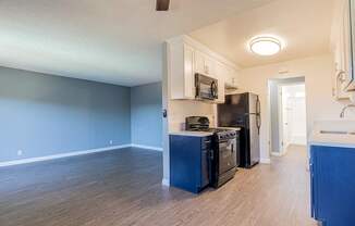 A kitchen with blue cabinets and appliances.