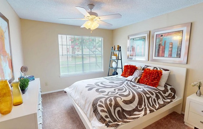 Bedroom with a bed, a ceiling fan, and a window.