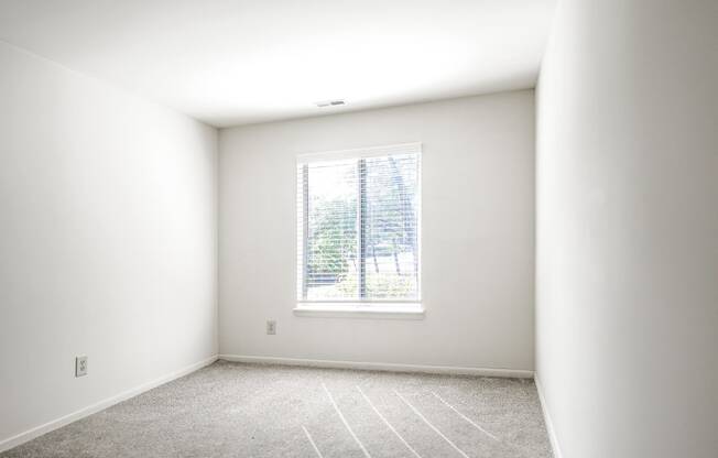 a room with white walls and a window