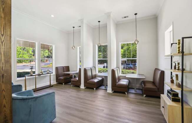 A waiting room with brown leather chairs and a blue sofa.