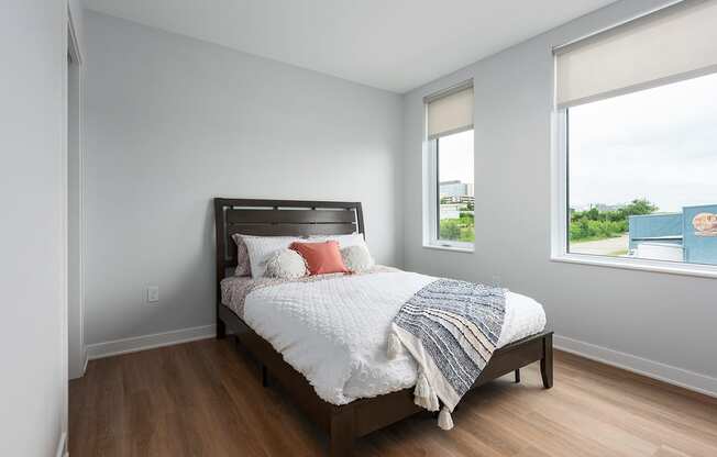 bedroom with plank flooring and large windows at Steelcote Square, St. Louis, 63103