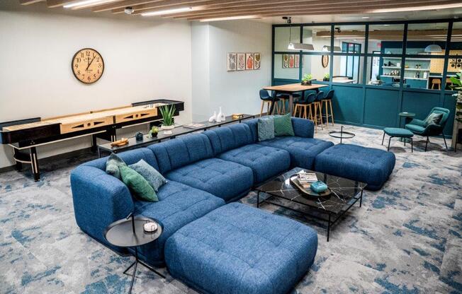 a living room with a blue couch and a table