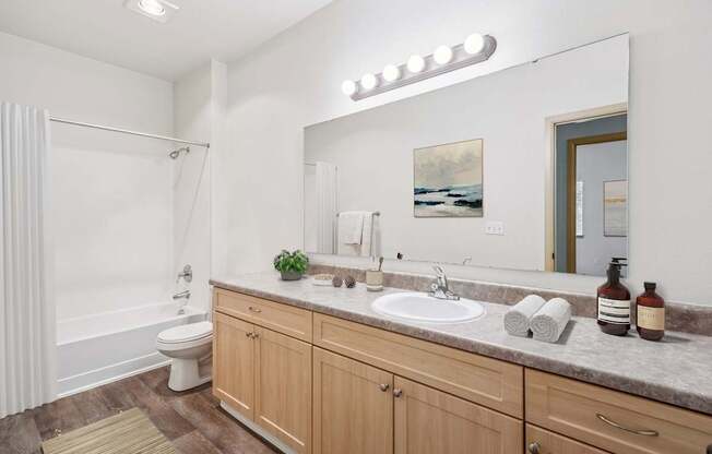 Master bathroom for Jackson floor plan with large vanity, toilet and shower at The Madison apartments in Olympia, WA