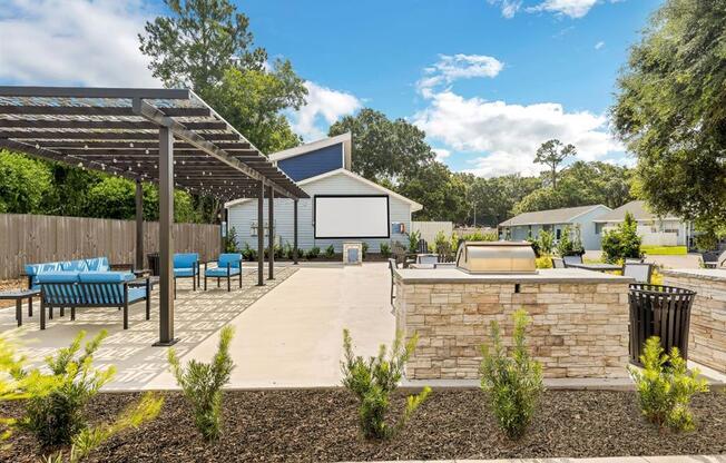 a patio with a stone wall and a fire pit