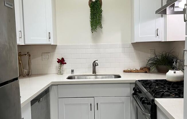 Kitchen with lots of white cabinets in apartment at The Carlton in Hollywood, California.