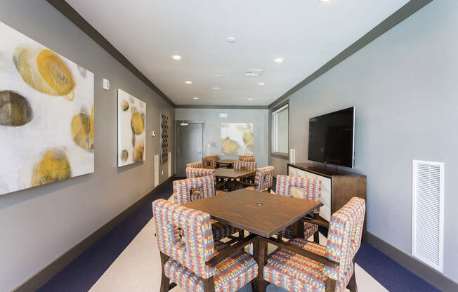 Conference room with tables chairs and tv  at LandonHouse in Lake Nona