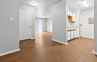 A room with wooden floors and white walls.