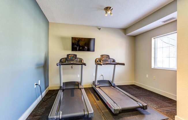 the treadmill area in the fitness room at the whispering winds apartments in pearland, tx