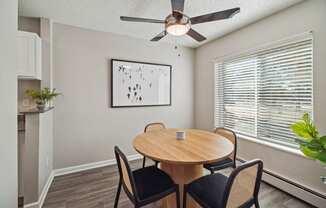 a dining room with a table and a ceiling fan