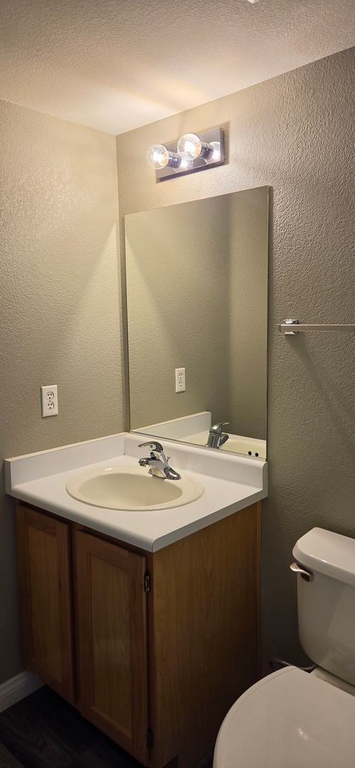 Two story 2 bedroom townhome with newer flooring, paint & appliances - community pool!