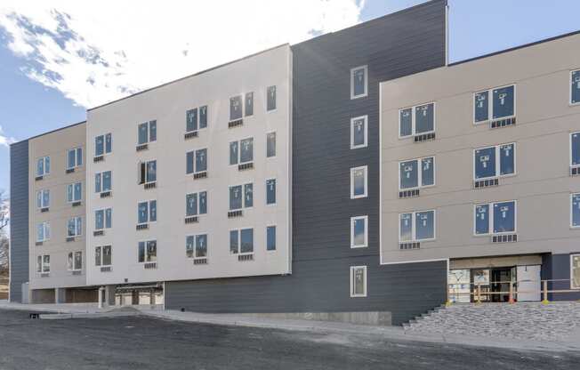 a large building with many windows and a street in front of it