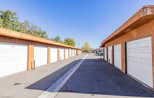 a row of garages with white garage doors