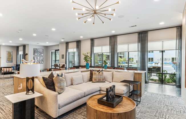 a living room with a large couch and a chandelier