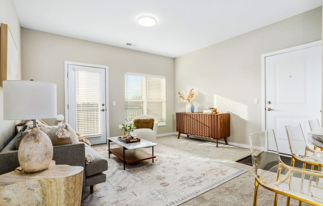 a living room with a couch and chairs and a table