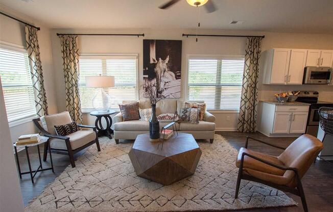 a living room with chairs and a table