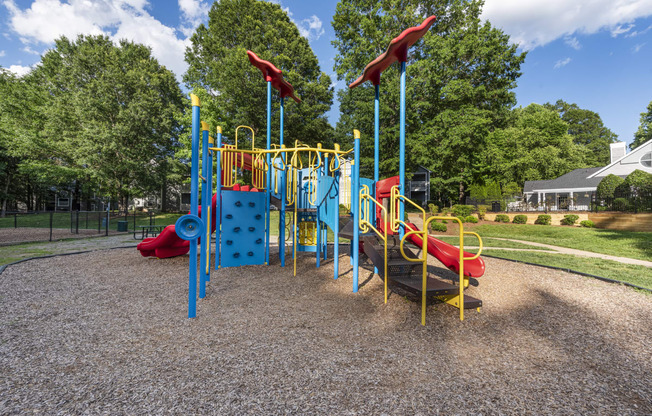 a playground at a park with slides and trees