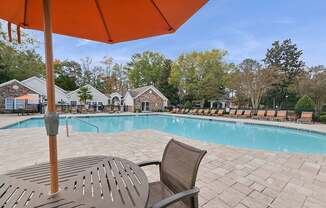 Community Swimming Pool with Pool Furniture at Lake Cameron Apartments located in Apex, NC.