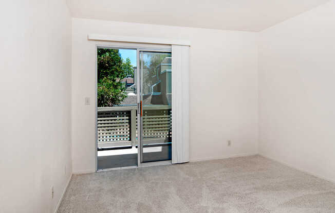 Carpeted Bedroom with Balconyy