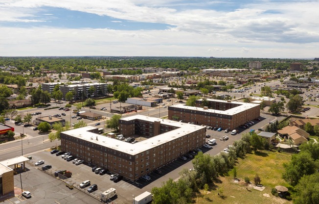 an aerial view of a city with buildings and cars