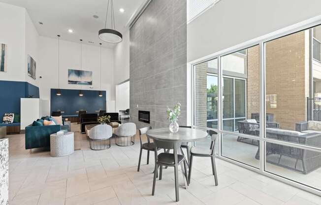A modern living room with a dining table and chairs.