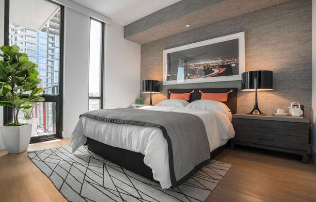 a bedroom with a bed and a painting on the wall