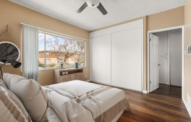 a bedroom with a bed and a ceiling fan