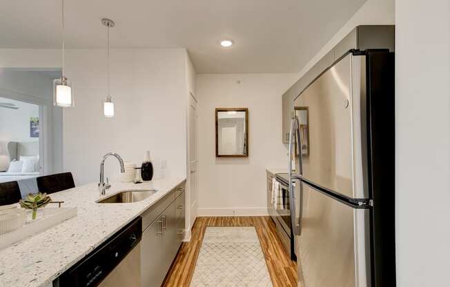 a kitchen with granite countertops and stainless steel appliances