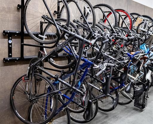 A wall-mounted bike rack is full of bicycles.