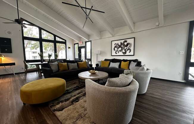 a living room with couches and chairs and a rug