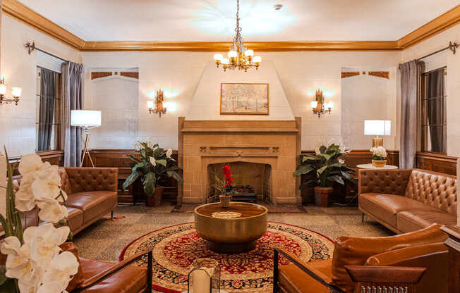A living room with a fireplace and a chandelier.