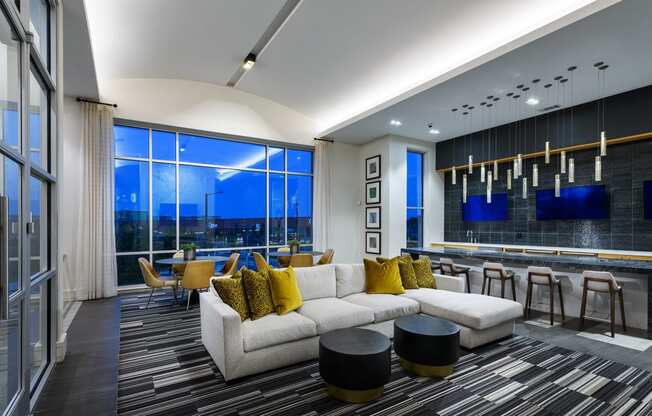 a living room with a white couch and a table with chairs