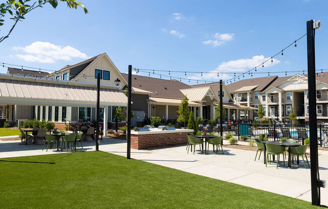 a patio with tables and chairs in front of houses