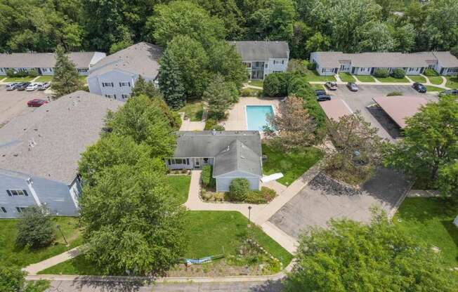 a aerial view of a neighborhood with houses and a pool