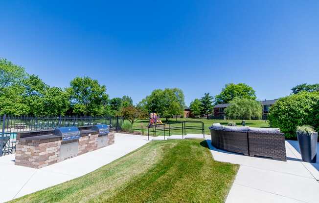 Playground, grilling station, and swimming pool at  Ashton Brook Apartments