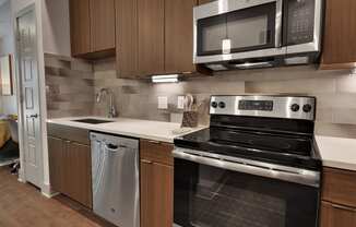 a kitchen with wooden cabinets and stainless steel appliances