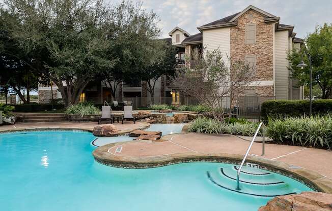 A swimming pool with a slide in the middle of it.