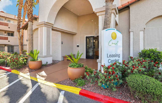 The leasing center of a building with a yellow and white sign.