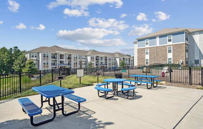 our picnic tables are set up in front of our apartment buildings