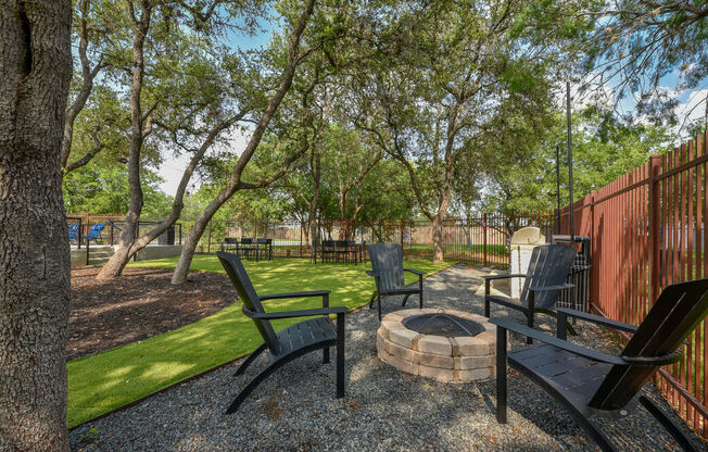 a patio with chairs and a fire pit