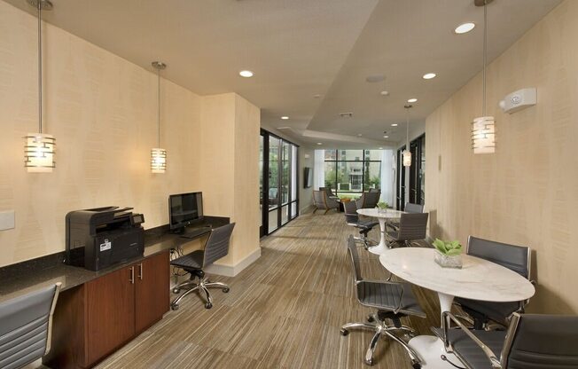 a large office space with desks and chairs and a television