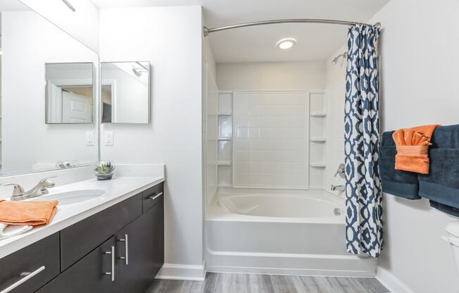 a bathroom with a shower and a sink and a bath tub