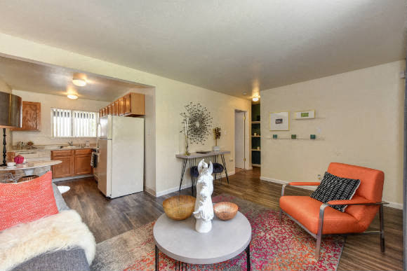 Living Room with Hardwood Inspired Floors, Orange Chairs and Table