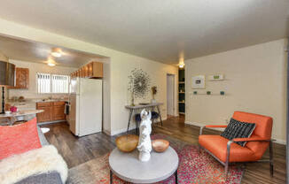 Living Room with Hardwood Inspired Floors, Orange Chairs and Table