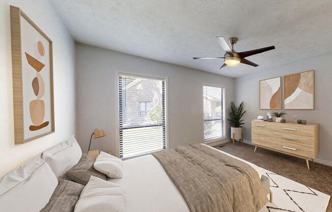 a bedroom with a large bed and a ceiling fan