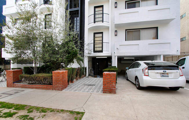 an apartment building with a car parked in front of it