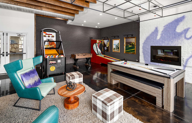 a games room with a foosball table and arcade games at Abberly Noda Vista Apartment Homes, Charlotte, NC